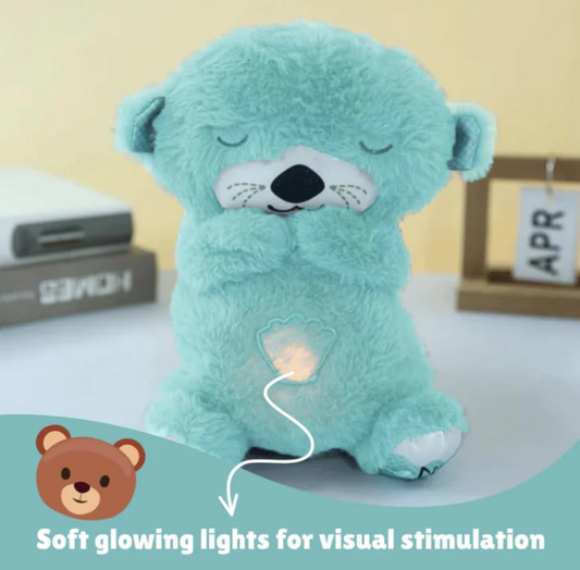 Light blue teddy bear with glowing light on a white surface, labeled for visual stimulation.