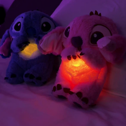 Blue plush toy with heart-shaped belly on a white pedestal against a light blue background, labeled 'The Soulful Stitch'