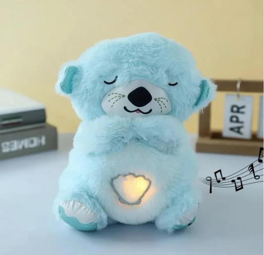 Light blue teddy bear with a heart design on a white surface