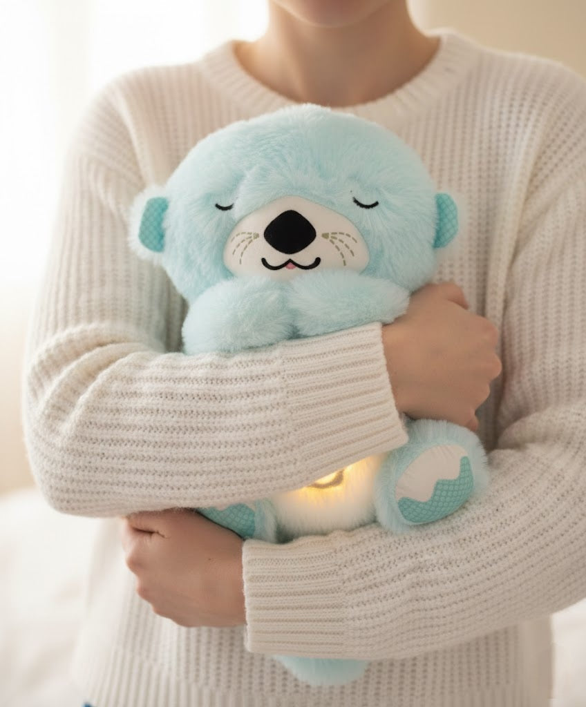 Person holding a light blue plush toy with a white background